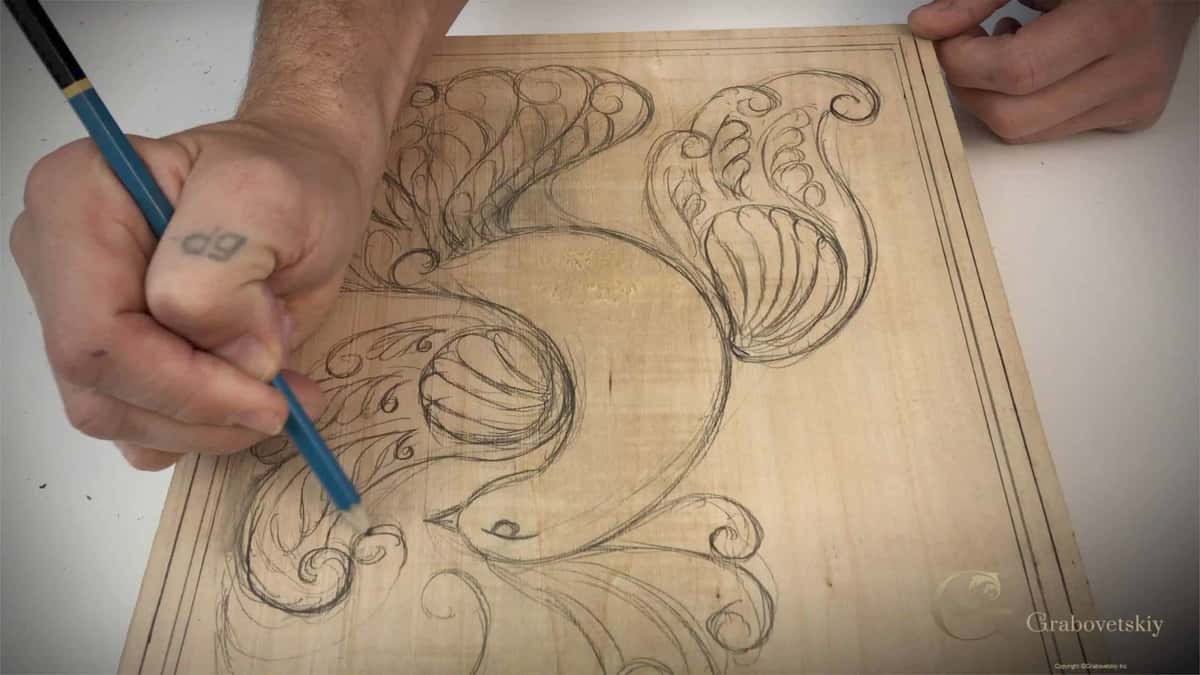Blue pencil drawing the scrolled design