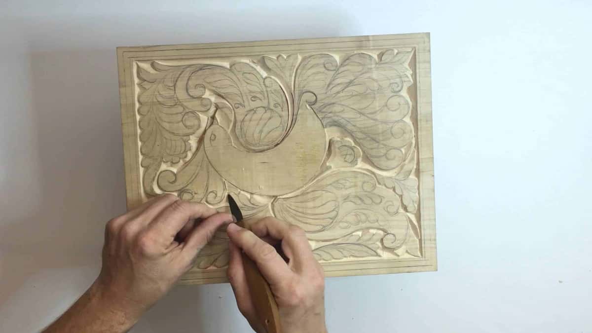 From above, both hands bring the knife down to the lower border