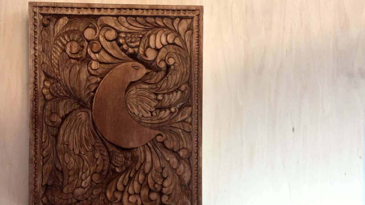 The finished panel standing alone, every hollow still dark and each ridge catching the lamp light