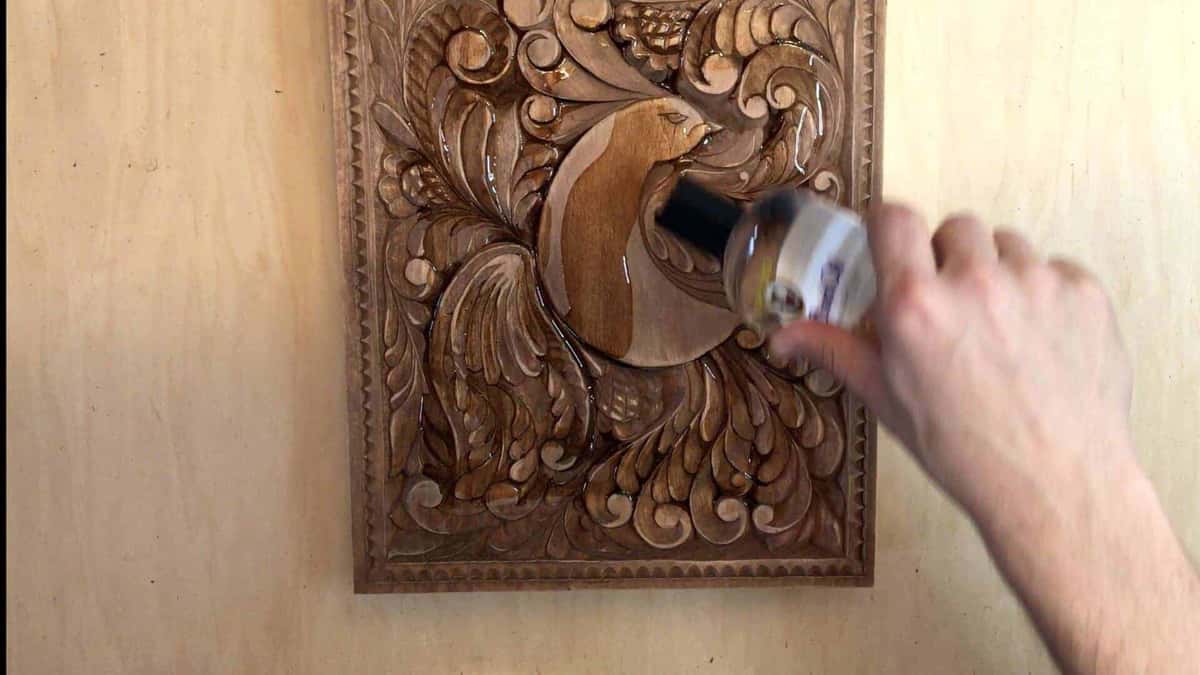 Dark liquid pooling over the deep carved leaves