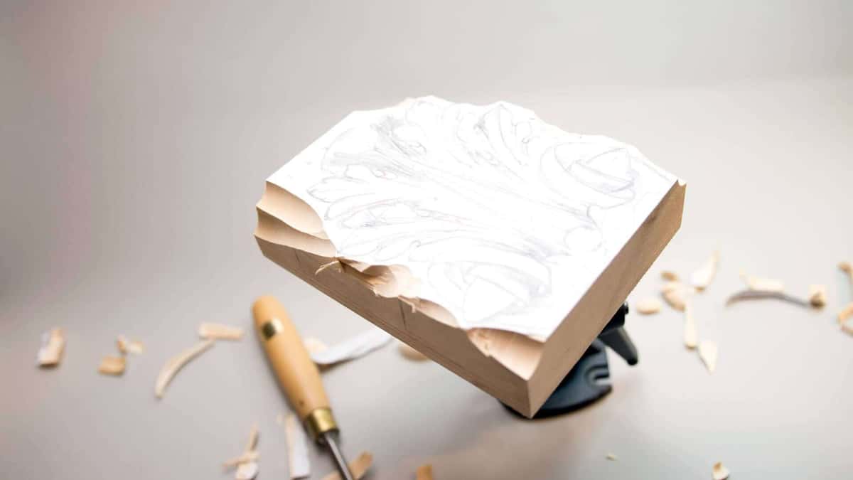 Roughly sawn limewood block with the relief design drawn across it