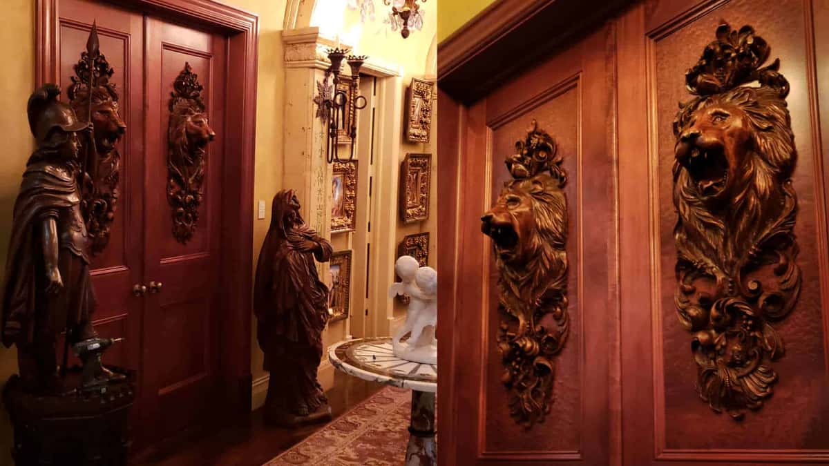 Lion head onlays mounted on dark mahogany doors, shown in two photographs