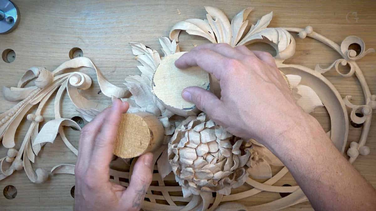 Two round blanks set beside a carved flower on the openwork panel.