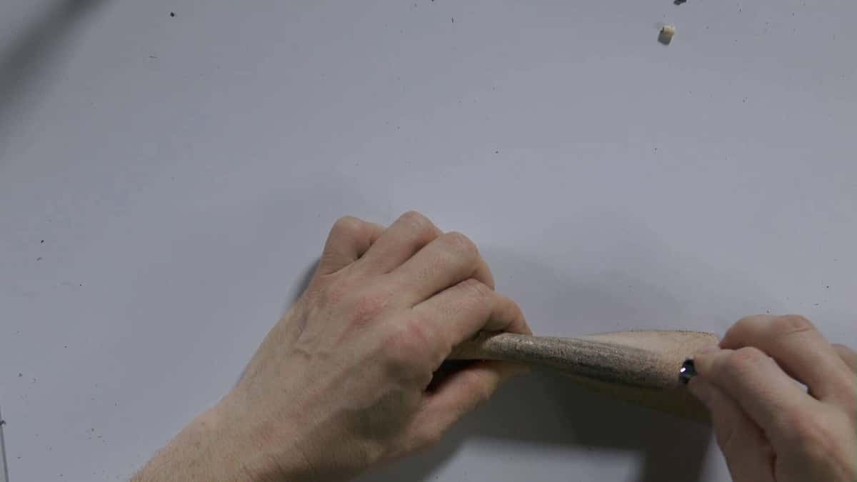Stropping a carving gouge on smooth leather to take off the wire edge