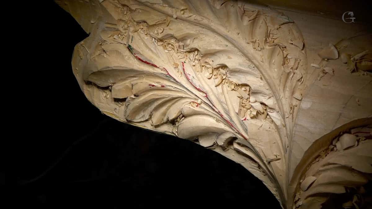 Deep acanthus leaf on a large curved cornice section, loose chips still caught in the veining.