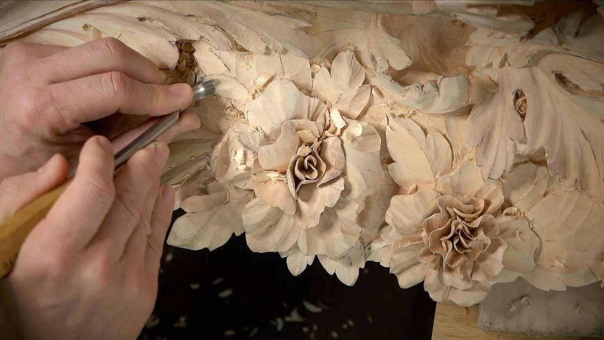 Alexander Grabovetskiy passionately carves beautiful flowers from a block of basswood, showcasing his expert woodcarving skills as a dedicated carver. Using a variety of carving tools including sharp wood carving knives, gouges of various sizes, and a chisel, he employs advanced techniques like chip carving to shape intricate floral sculptures. Surrounded by his carving supplies, Alexander utilizes a mallet and selects suitable tools from his beavercraft kit, demonstrating proper tips for sharpening blades. As he works, he also explores spoon carving and the basics of whittling, creating decorative wooden figurines that capture the attention of both beginners and experienced woodworkers. This beautiful wood grain reveals texture and charm, reflecting his unique wood carving style. For those interested in woodworking, he shares step-by-step guidance on his YouTube channel, where he discusses various techniques, tools, and offers suggestions on how to create beautiful objects for furniture decoration or as animal sculptures. This image captures the essence of Alexander's woodworking journey, inspiring others to develop their skills in the art of carving