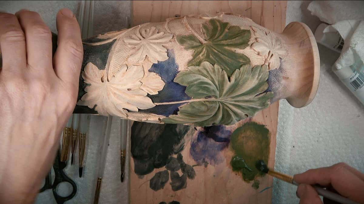 Half the grape leaves pale wood, half painted green.