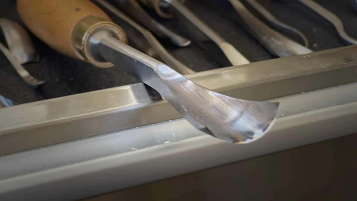 Arc edge of a carving gouge above the tool rack