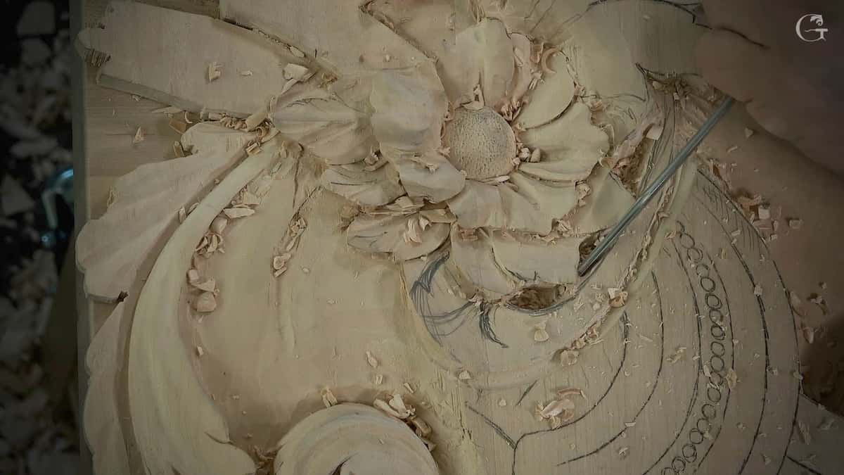 Carved flower with a punched center, chips still lying between the petals.