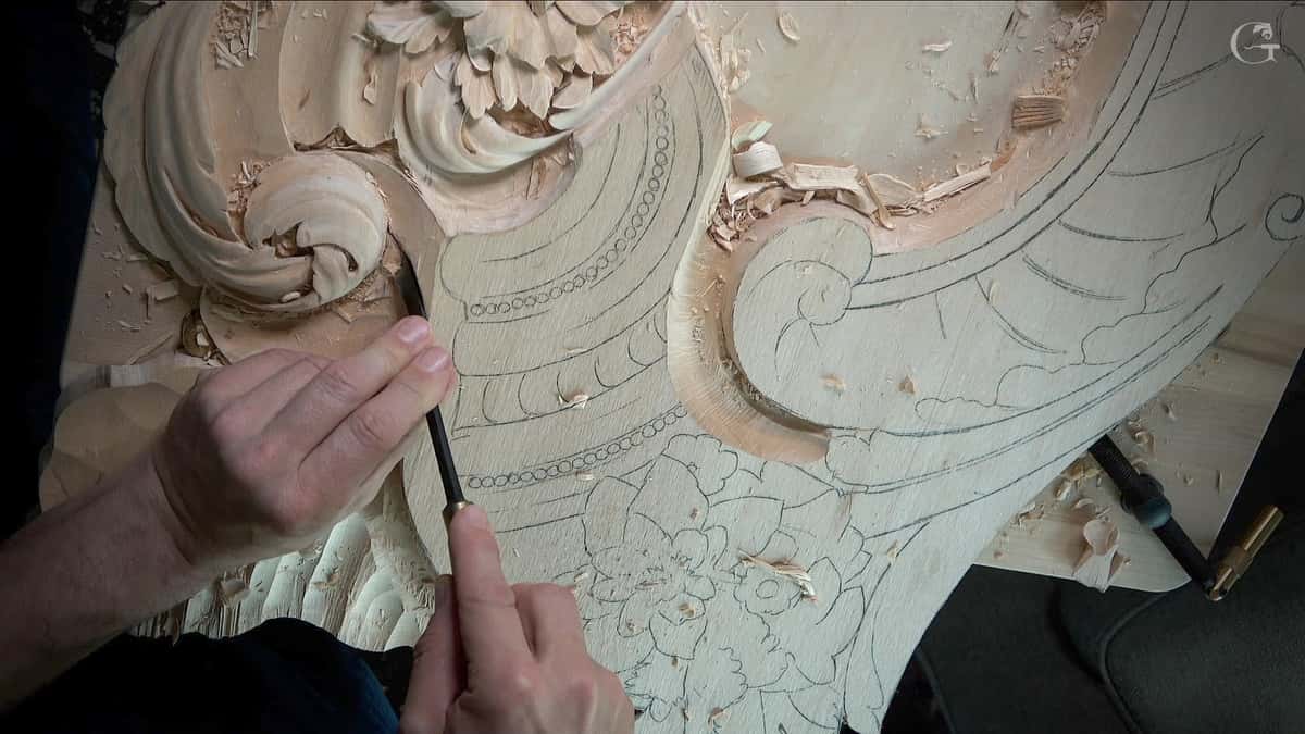 Pencil drawing on one half, carved volutes on the other.
