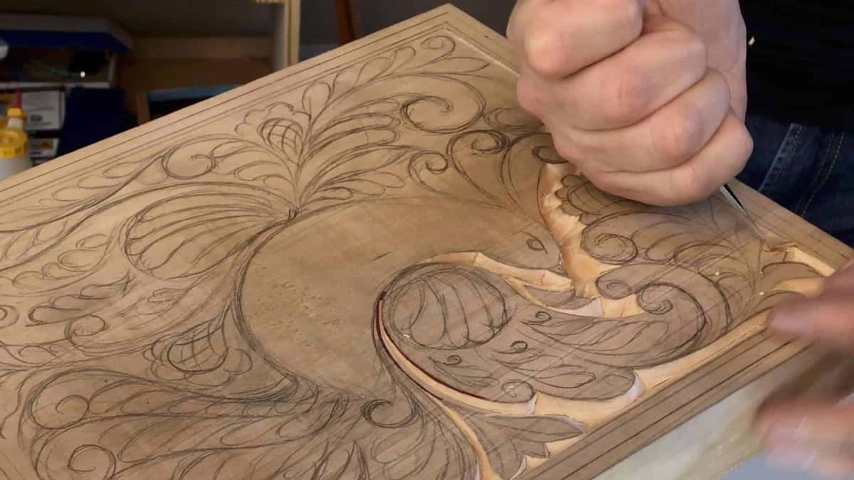 Chisel entering a relief panel at the point where the leaf turns into end grain