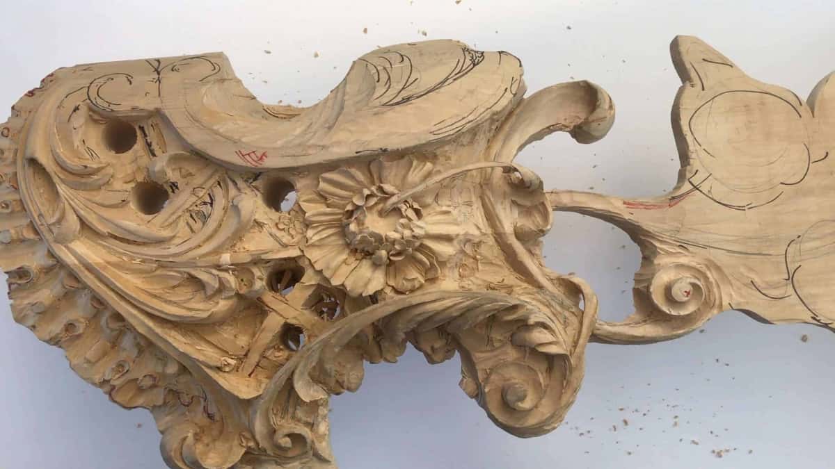 Whole high relief panel, rosette at its center and every scroll undercut so the ground drops into black