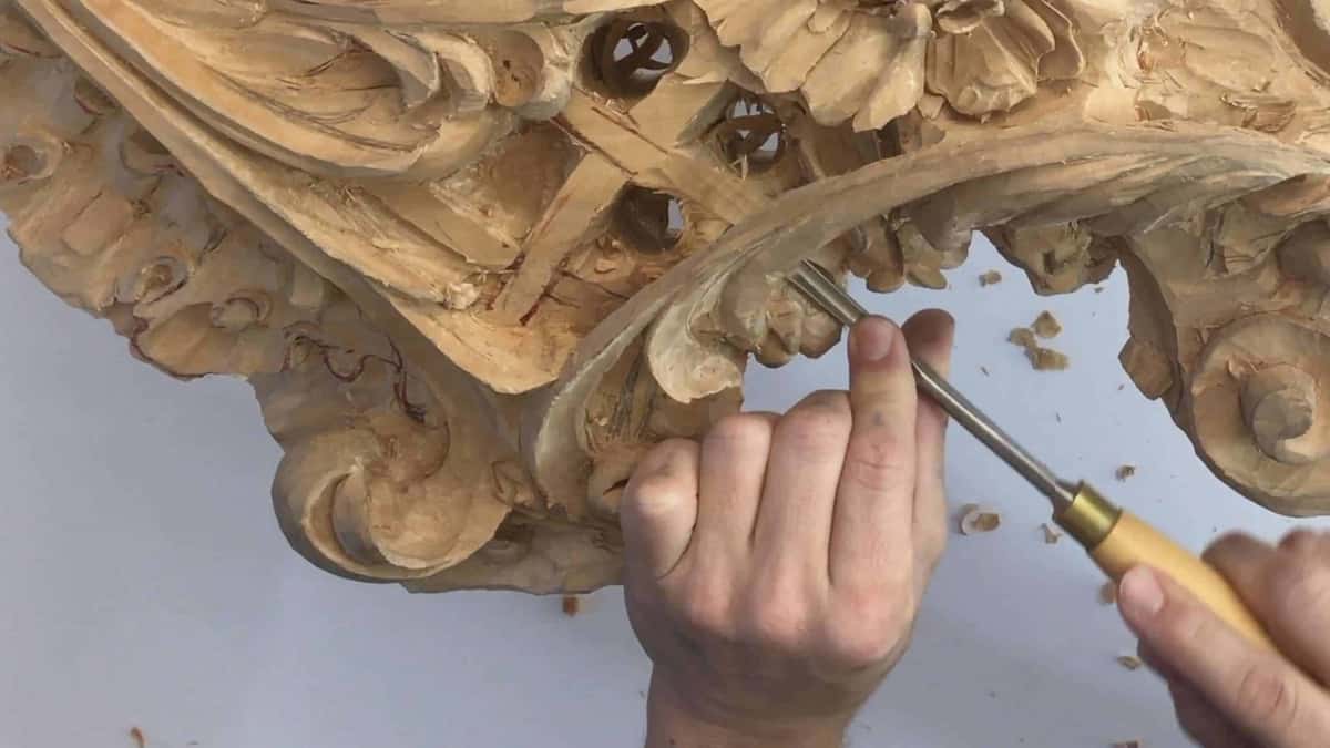 Slim gouge reaching into the undercut of a Grinling Gibbons style high relief