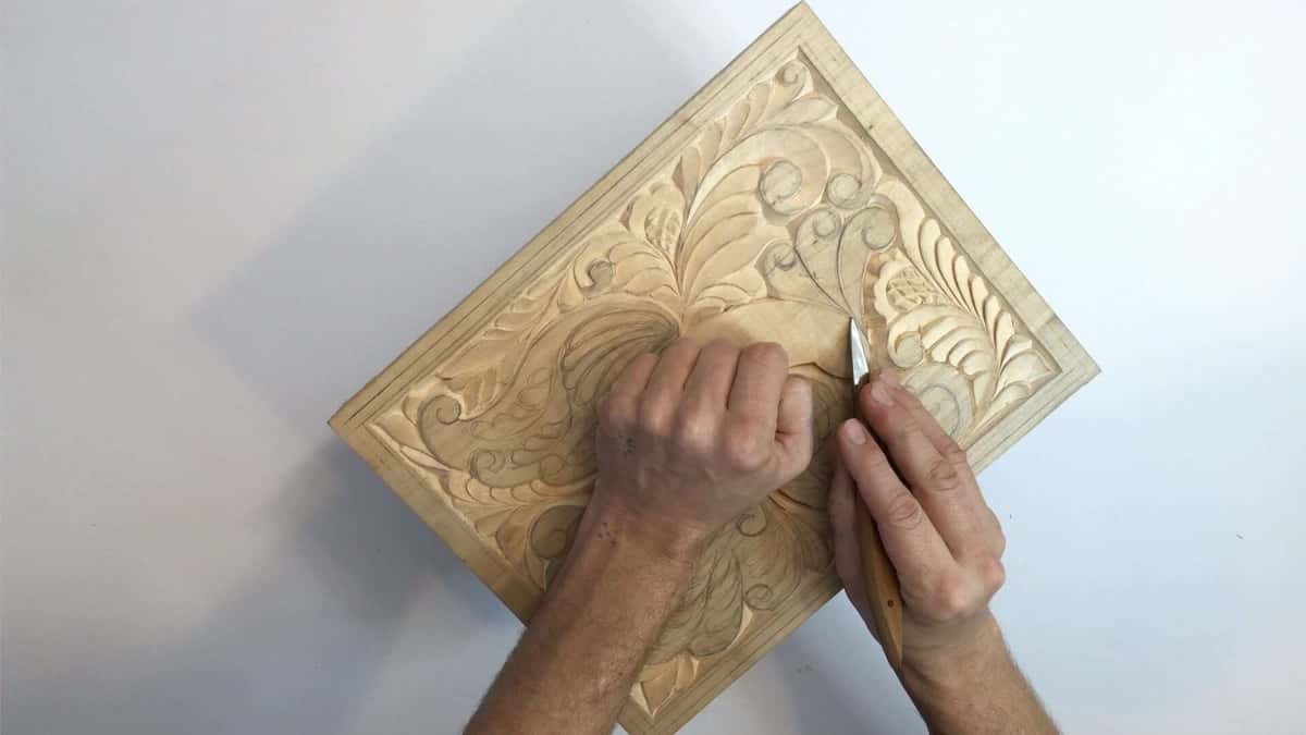 Gouge working a carved acanthus
