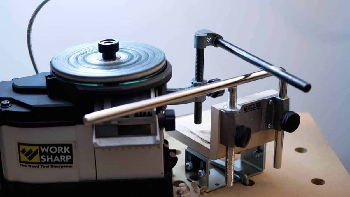 A Work Sharp disc machine with a Tormek bar attachment bolted on beside it