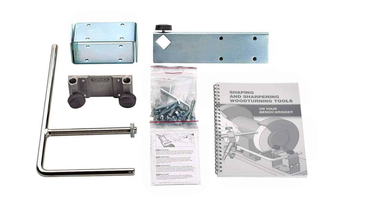 Tormek bar attachment kit for a bench grinder, laid out with all its hardware and the manual
