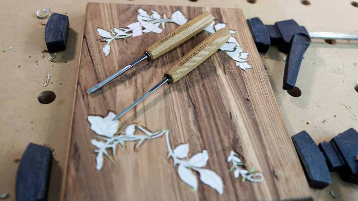 Two Swiss gouges on dark boards