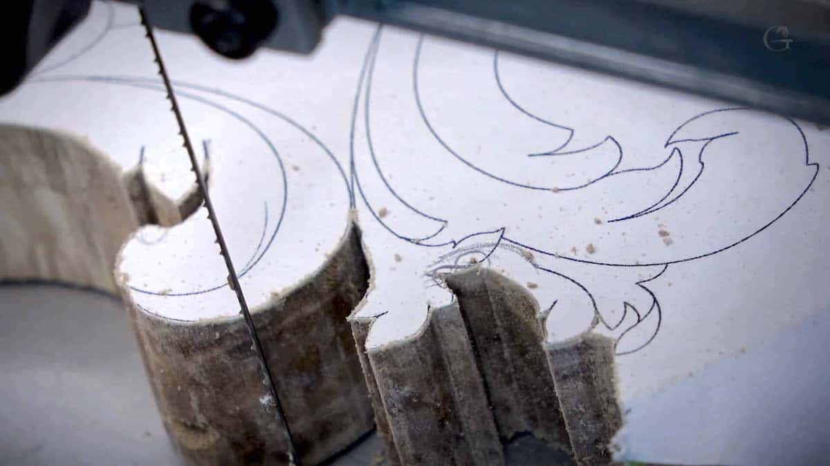 Bandsaw blade parting a primed board along a drawn line