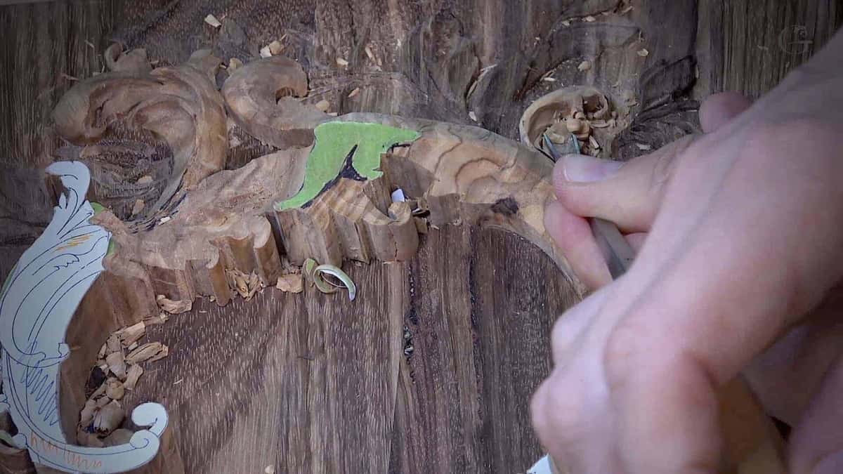 Short broken chips beside a carved olive wood leaf