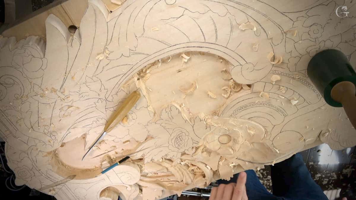 Half carved basswood panel with pencil ornament drawn across one side