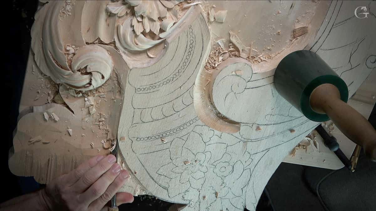 Mallet driving a gouge through wood