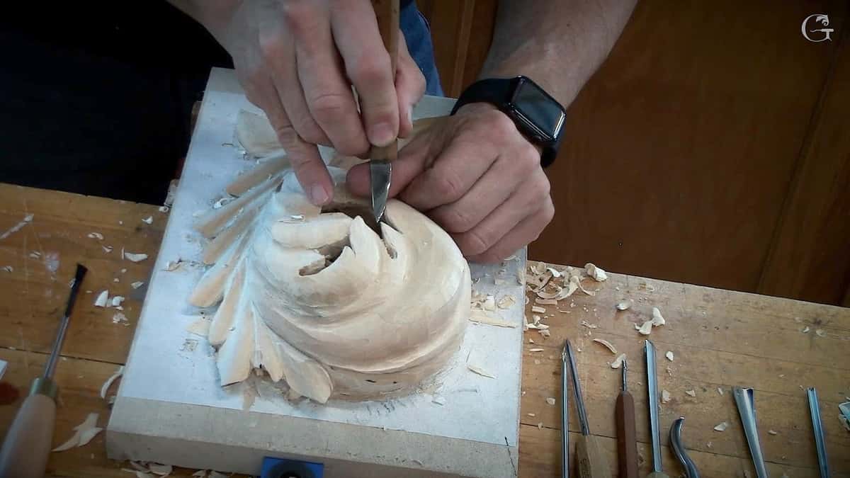 Round rosette being modeled while tools wait on the bench