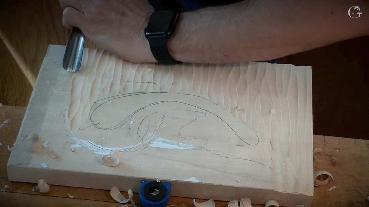 Gouge scalloped background ringing a pencil acanthus outline on a basswood board