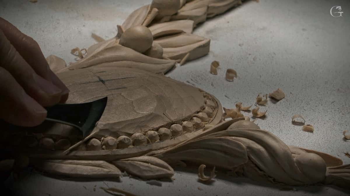 Bead border and a leaf being sliced with one wide flat gouge