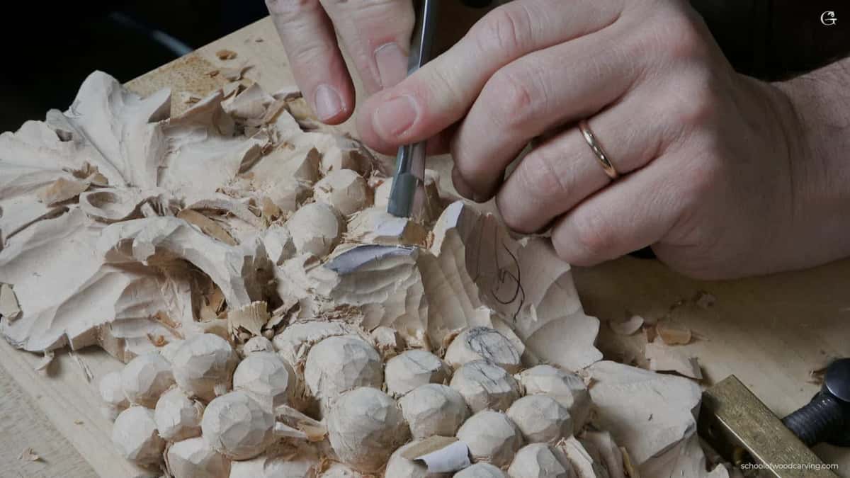 A small gouge works between roughed grapes where a wide tool would break the stems off