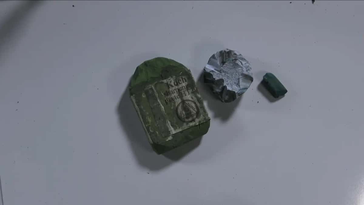 A green bar of sharpening paste beside a foil wrapped grey block and one small green offcut.