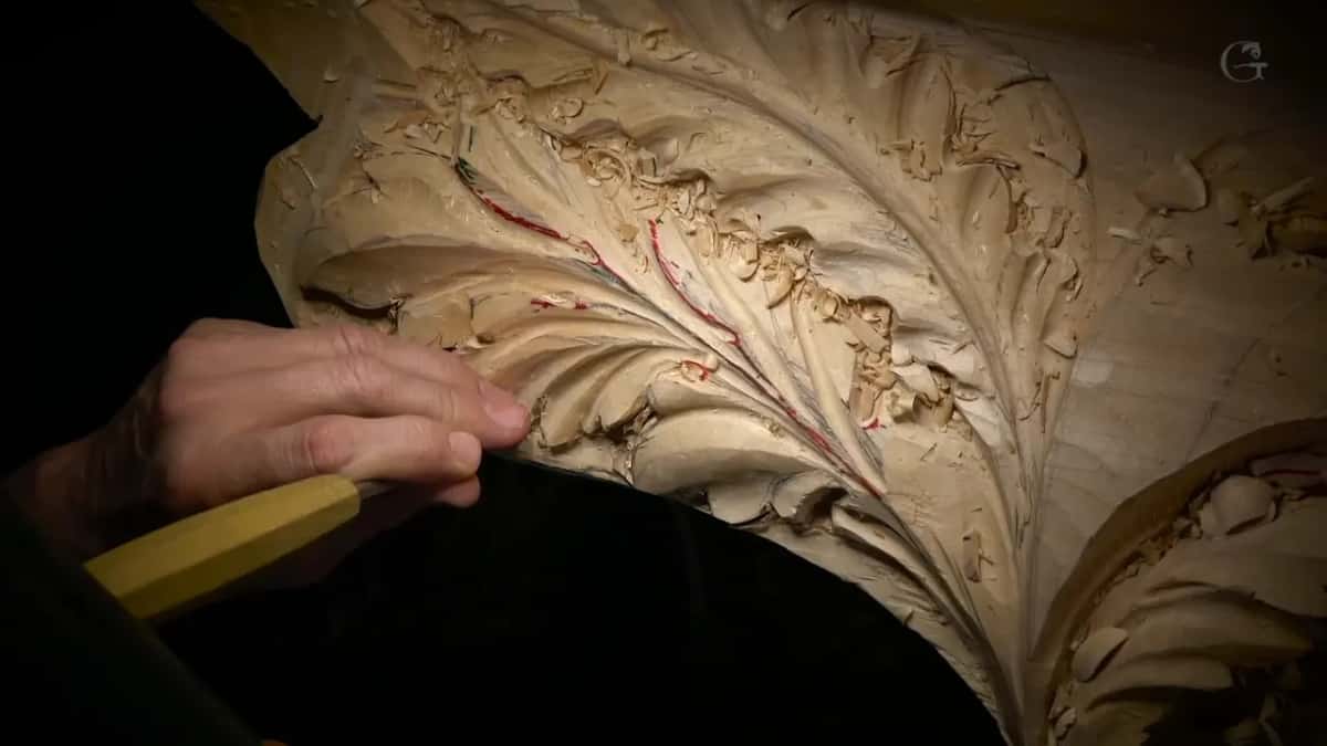 Chipped spots along the veins of a big acanthus leaf.