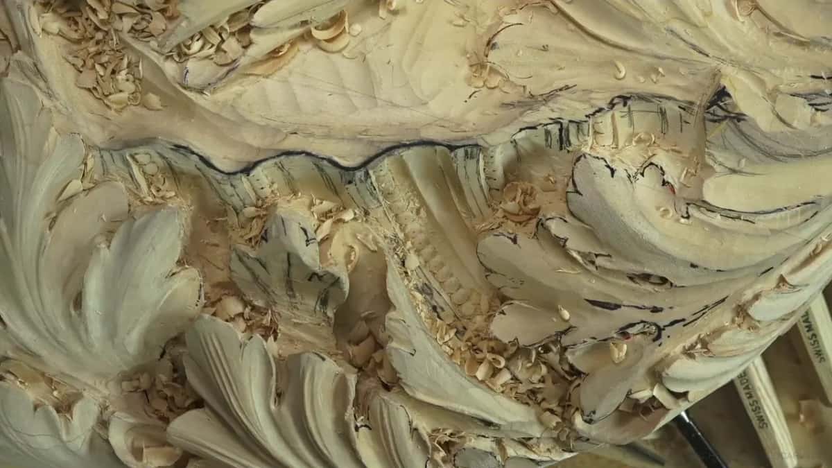 Cream coloured leaves curl over each other in deep relief, with loose chips caught in every hollow.