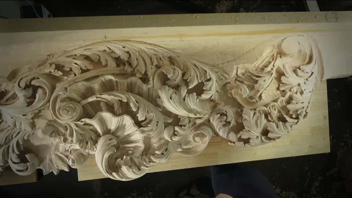 The full length of a deep acanthus frieze, scrolls and leaves standing free of the ground
