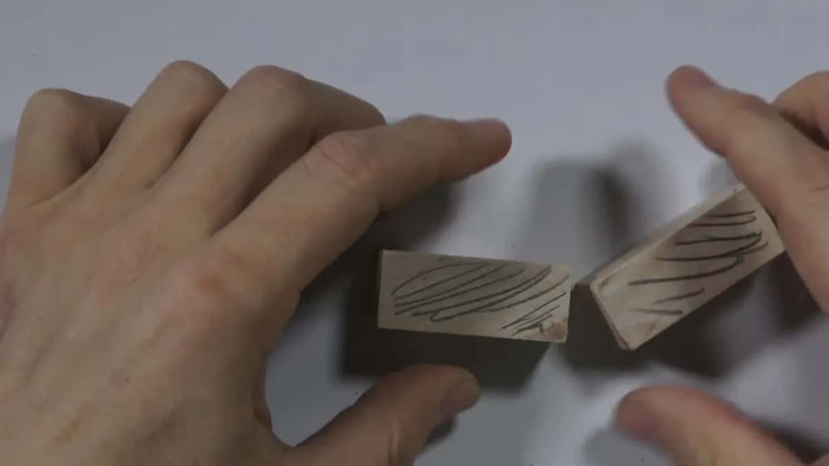 Wood blocks marked with drawn grain lines placed side by side for comparison.