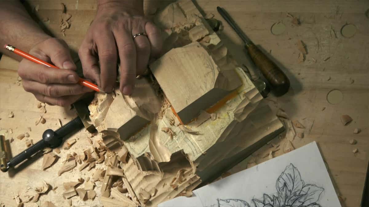 Pencil marking a roughed hazelnut carving