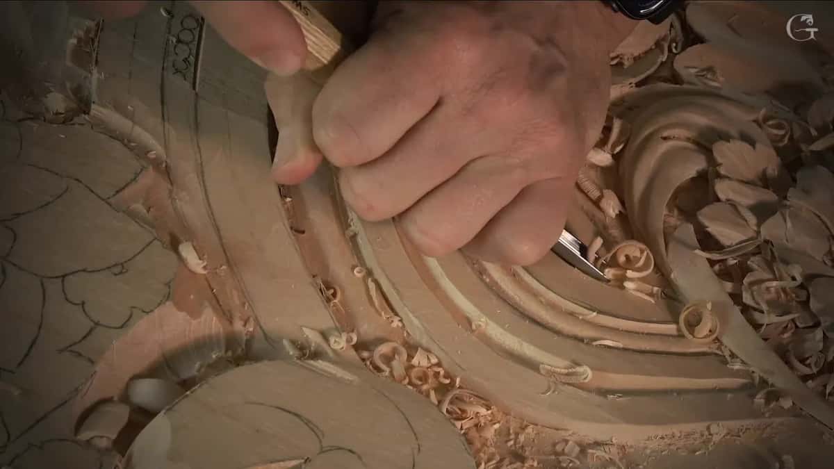 Fist wrapped round the handle as fresh curls pile up in the groove below it