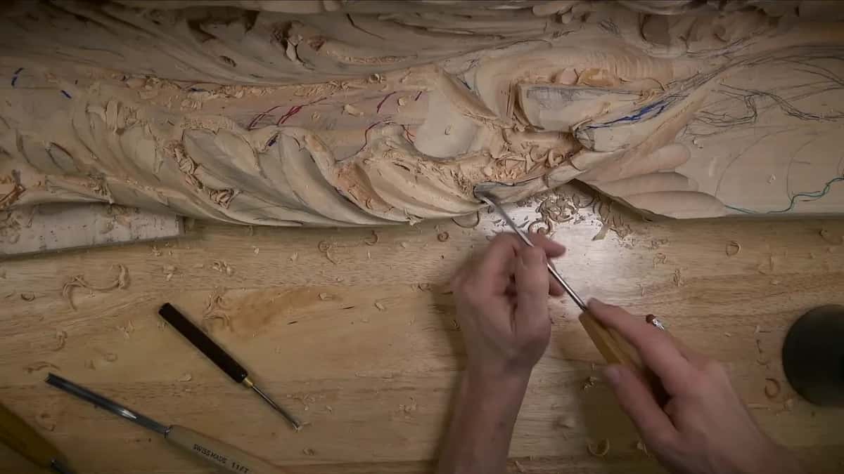 From above, a long thin shank reaches the edge while two chisels wait on the bench