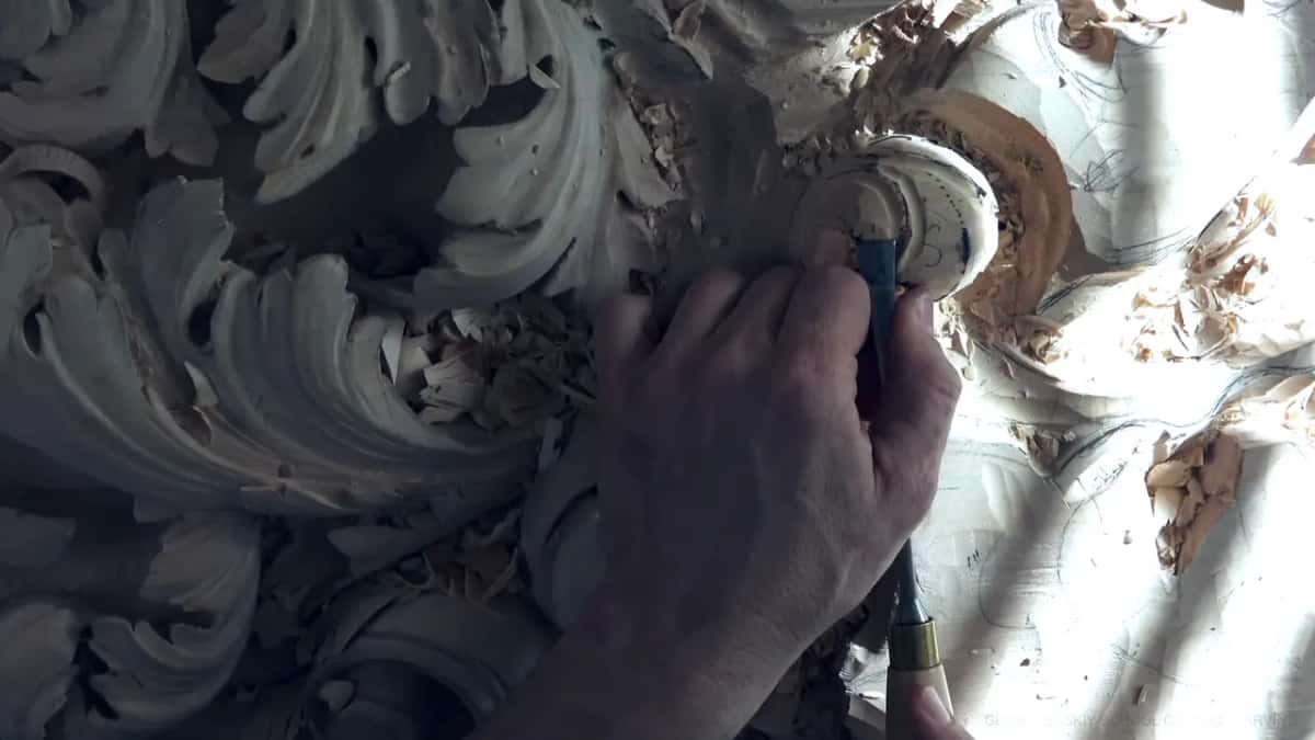 A hand presses a tool into the dome.