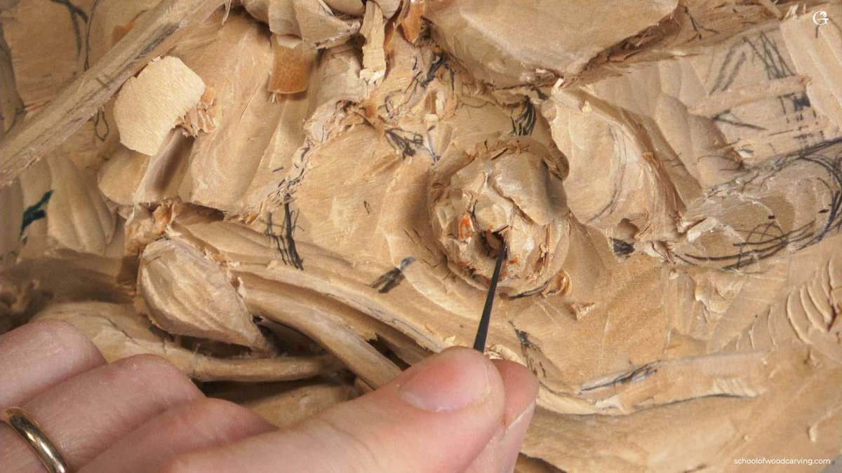 Close-up shot of a wood carving project, showing a skilled hand using a detail tool on soft wood. The intricate patterns and textures highlight the care involved in wood carving. This image represents the artistry found in wood carving classes and lessons, where enthusiasts learn to create beautiful pieces.
