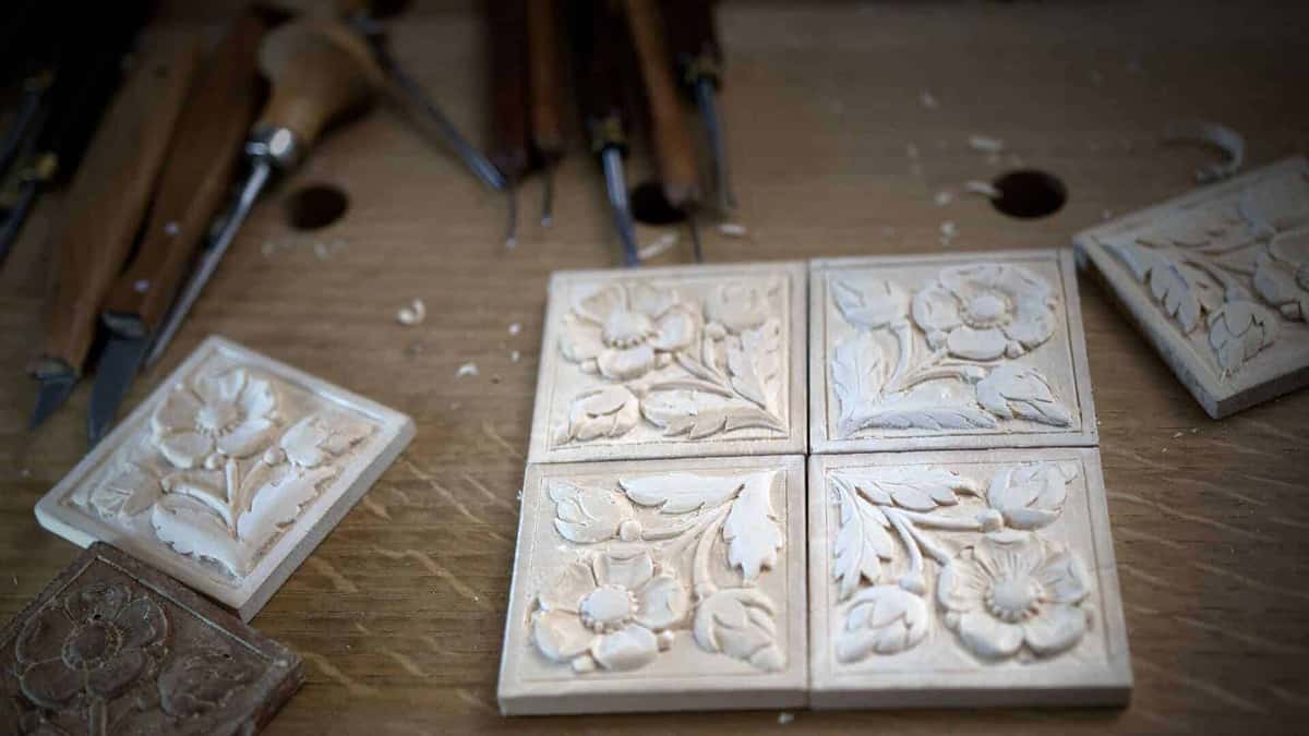 What comes off a small block Six small carved rosette tiles laid out beside waiting gouges
