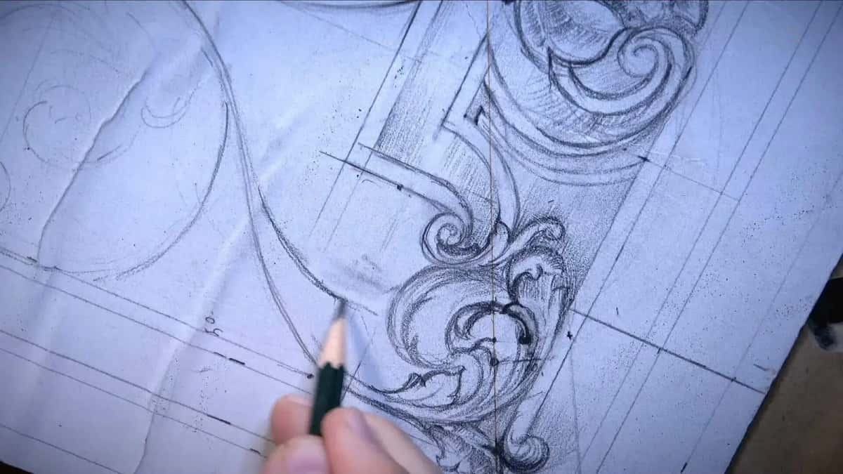 A Baroque scroll drawn in pencil over a ruled grid, before any wood is removed