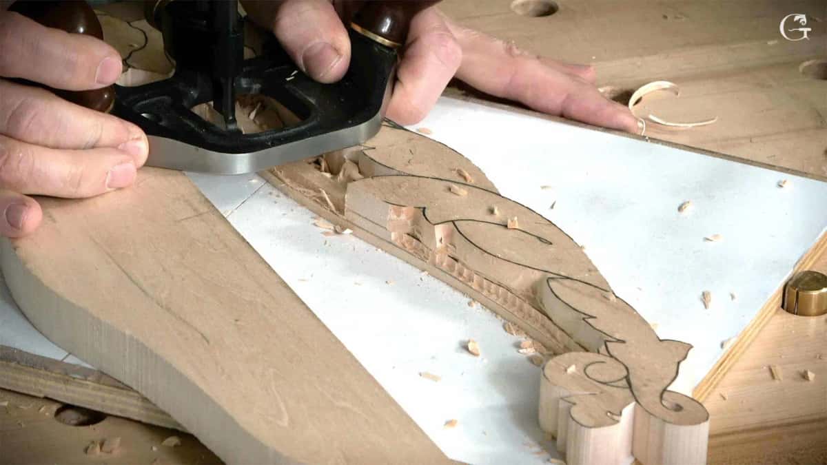 The acanthus design drawn in black onto the molding blank while a plane clears the ground beside it