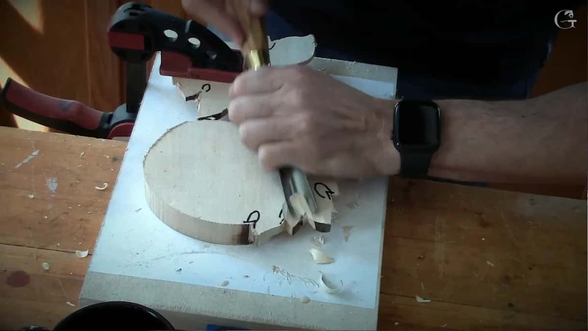 Panel clamped upside down so the lobes can be carved back underneath