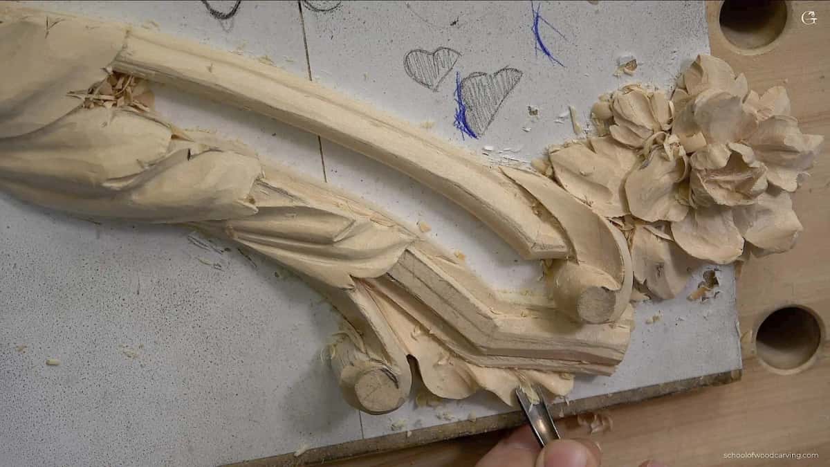 The finished acanthus running the full curve of the molding, with a carved rosette closing the end