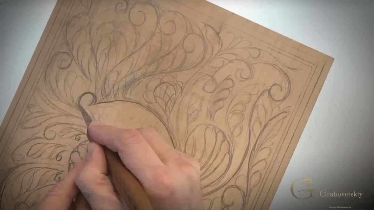 Knife carving around one large curl, the element known as a volute and older still as Solomon's cucumber