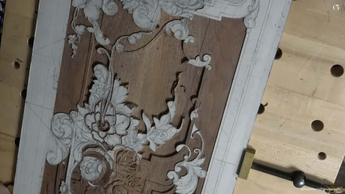 Carved walnut furniture panel in the bench vise Finished ornament in relief on walnut