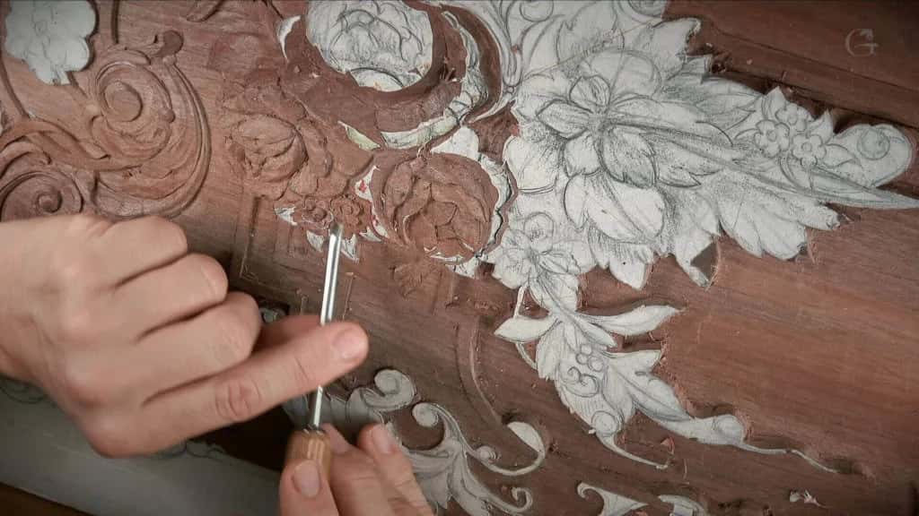 A furniture panel part carved, the drawing still showing on the untouched half