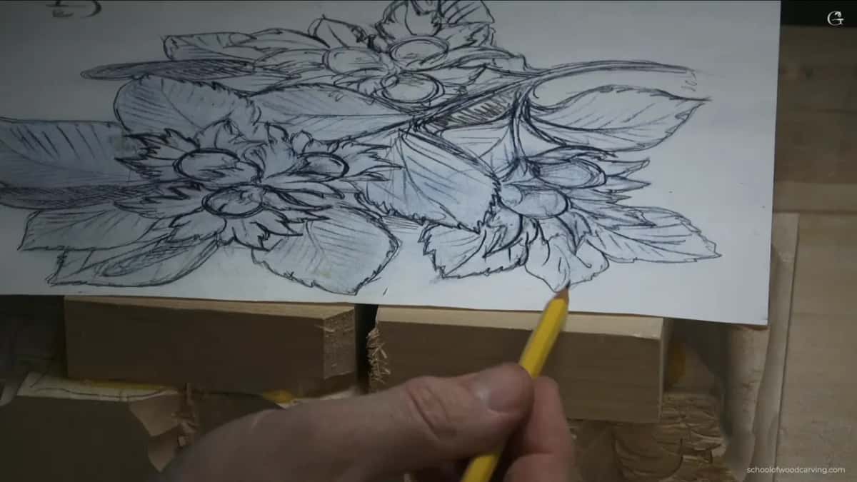 Planning the deep undercut beneath a leaf so the carved hazelnut cluster throws a real shadow and floats