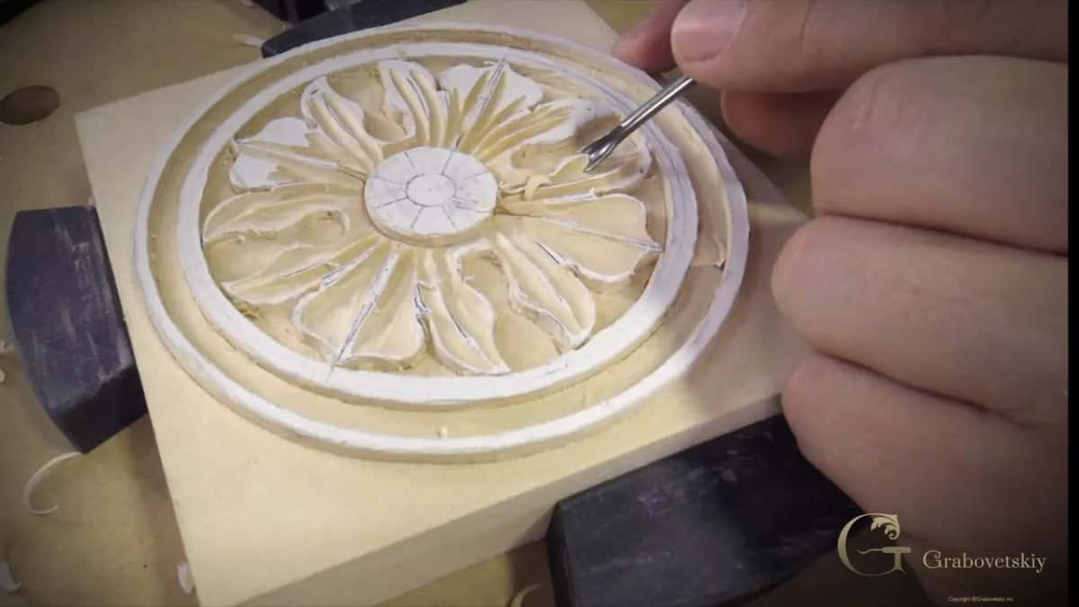 Small gouge tip set into one petal of the rosette, chalk marking the grounds around the shaped flower