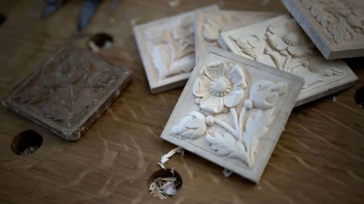 One worn antique tile at left, four fresh basswood copies of it at right